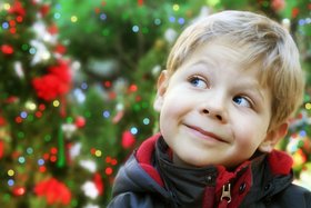 child, boy, kid, winter, holiday, christmas, season, december, joy, fun, lights, decorated, cold, outside, outdoors, blonde, caucasian, portrait, face, smile, happy, cheerful, green, childhood, cute, person, tree, xmas, sweet, little, small, tradition, smiling, white